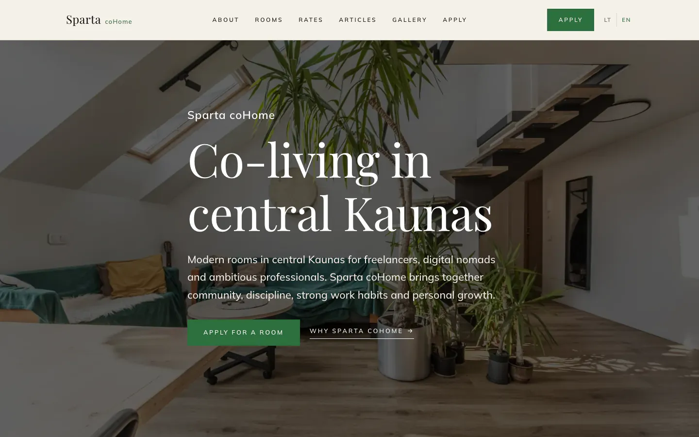 Sparta coHome homepage in English with the heading Co-living in central Kaunas over a bright loft living room with plants, and an Apply for a room button